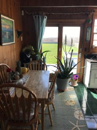 dining/kitchen area overlooking deck and grounds - Ocean Front/Private Beach