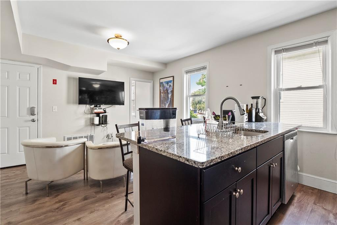 Living room with TV and kitchen - Modern and spacious room, only 3 min walking from Brown University Apartments