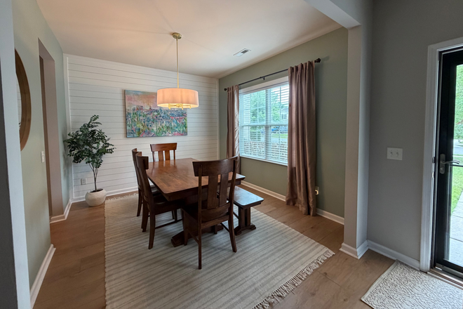 Large Dining Table with 6 Chairs and a Bench upon entering the Front Door of the Home - Fully Furnished 4 Bedroom House in Family Friendly Neighborhood