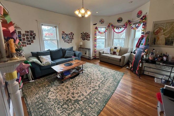 Living Room - Four bedroom apartment with two full bathrooms, laundry in unit, eat-in kitchen and central AC