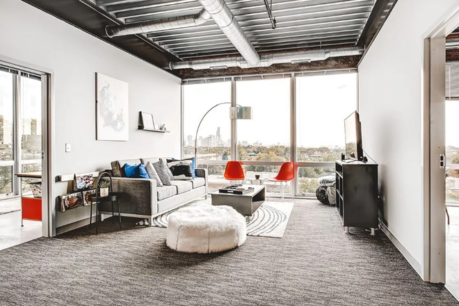 Lots of lounge space, wide window view, carpet - Ion Lincoln Park Apartments