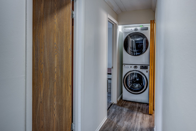 Hallway with washer and dryer - Cedar Village Apartments