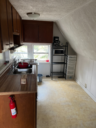 Kitchen includes refrigerator, small microwave, stove top. - SURROUNDED BY NATURE House