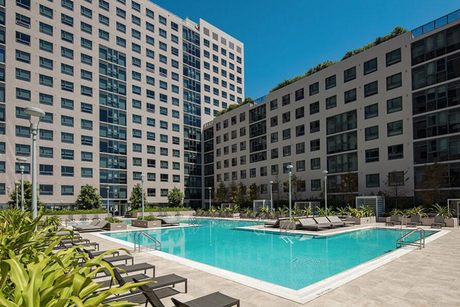 An image of the pool that is in the middle of the building - The One Apartments
