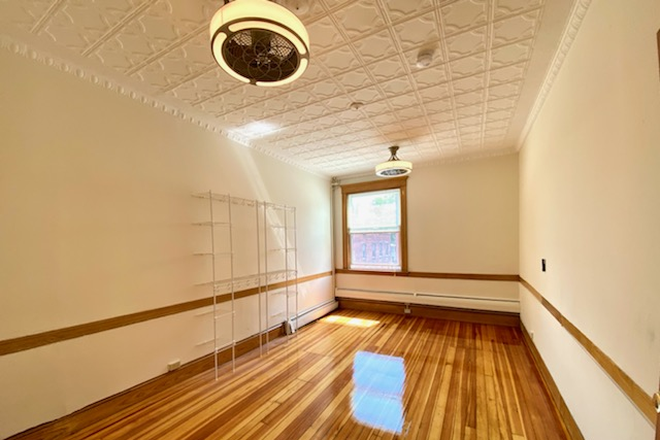 bedroom with hardwood floors - Available 7/1/26 Apartments