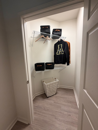 Walk-in closet with multiple shelves for storage - Boone Student Living Apartments
