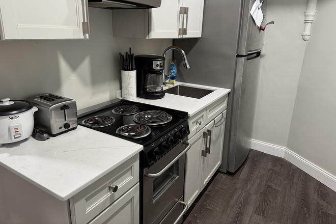 Updated kitchen with stainless steal appliances. Full size fridge/ freezer. Built-in microwave. Dishwasher. Stove and range. - Insane deal on beautiful studio near BC Apartments