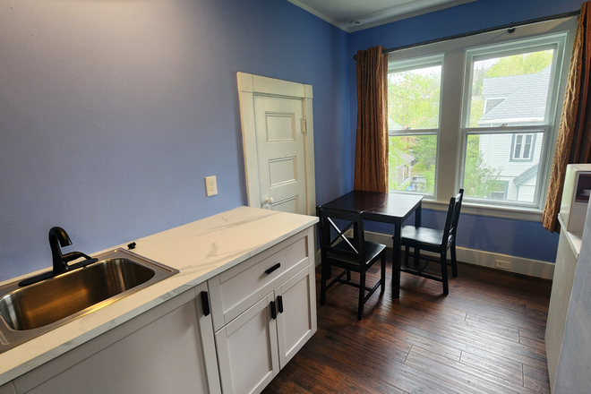 Sink, eating area - One bedroom furnished apartment on quiet street
