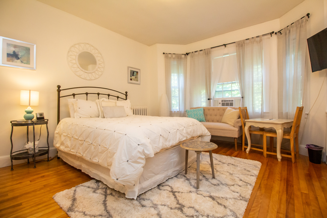 Bed and seating area - BEA1253C4 Cozy, Spacious Studio In Coolidge Corner Apartments