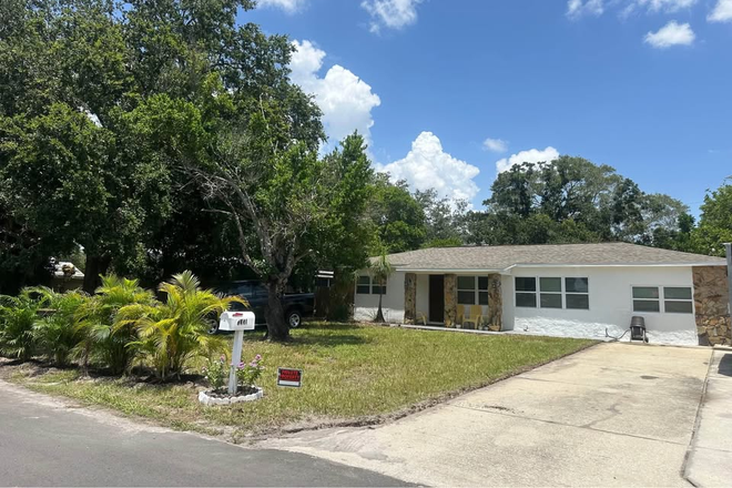 Front Yard and Driveway - Furnished Bedroom in Chill Central St. Pete House – $900/mo