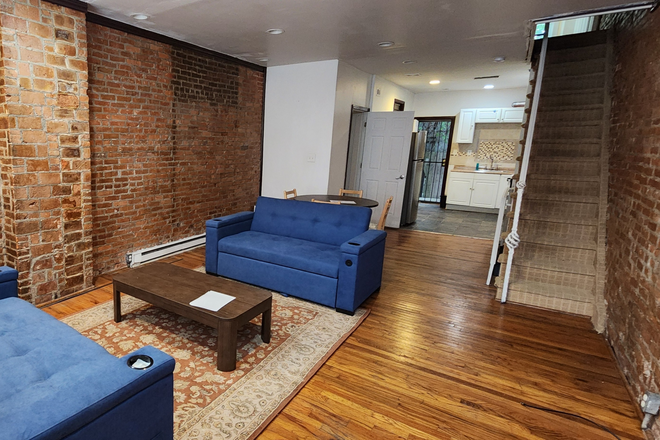 Living, dining, kitchen area - 3 Bedroom Furnished Townhome, 10-min Walk from Campus