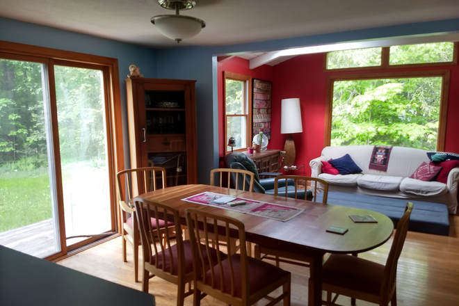 Dining Area and sunroom from edge of kitchen - Comfy, bright, furnished 3BR home on bus line