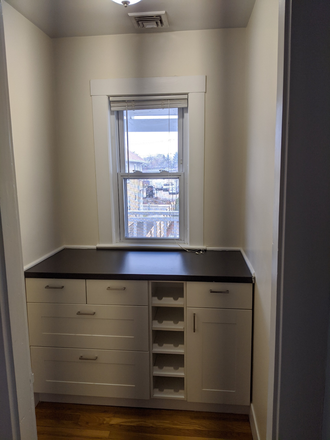 Kitchen pantry with built in wine rack - Spacious 2 Bedroom Apartment near Harvard Business School