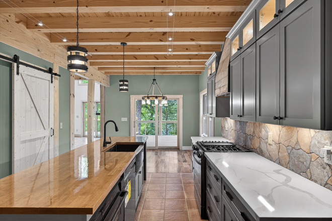 Kitchen looking on to the dining area and sliders open to lanai - The Lake House on Leesville Lake