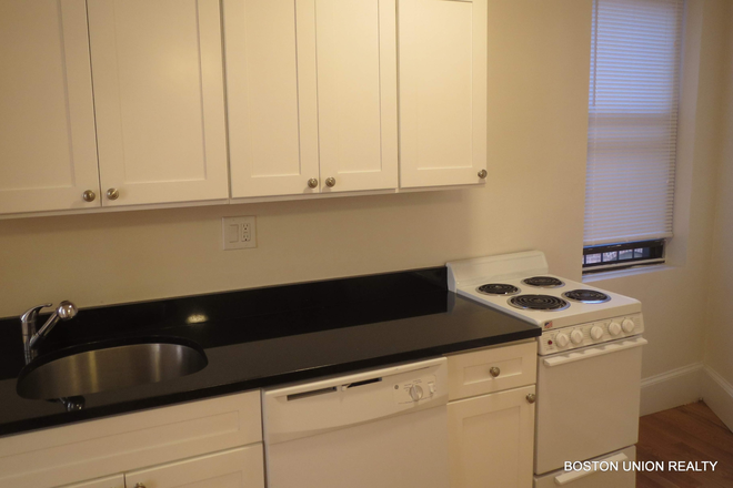 Kitchen, fire escape entrance - Sunny Back Bay Bedroom for Sublet