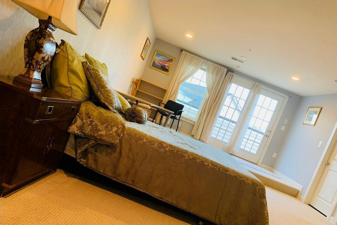 Master Bedroom : Includes private bathroom and an oversized walk-in closet. Furnishings are as shown in the photos. Monthly Rent: $1,400 - GBS Luxury master bedroom with private bathroom and balcony, and parking space, $1400/month. Townhome