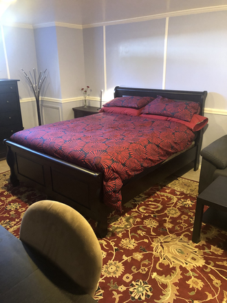bed as seen from bathroom door - Lovely, quiet basement apartment in single family home close to AU campus and law school