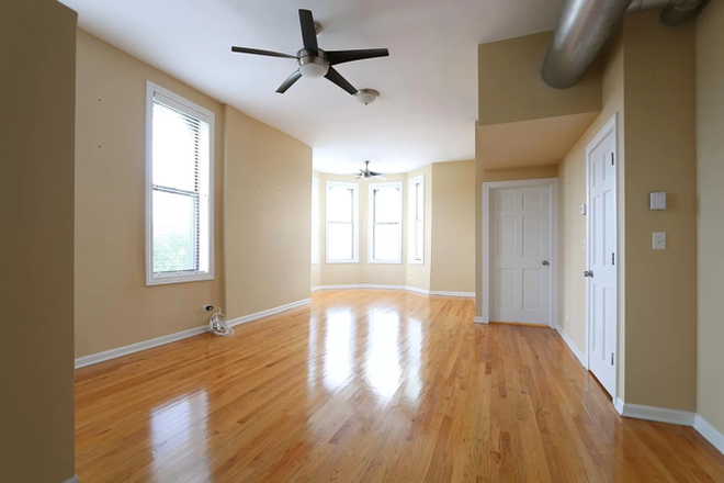 large living room - Top-floor 3BR in classic Taylor Street greystone — in-unit W/D, central A/C Apartments