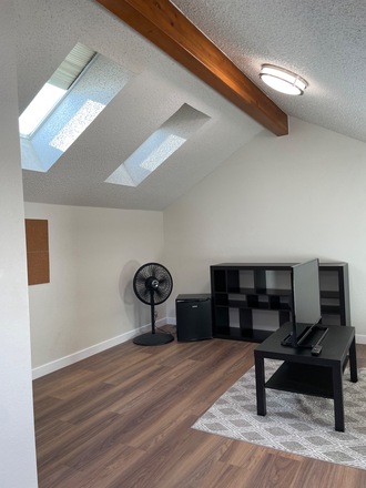 Furnished loft with skylights. Includes futon, coffee and side table, tv, bookcase, lamp, small fridge, fan - Gold Run Place