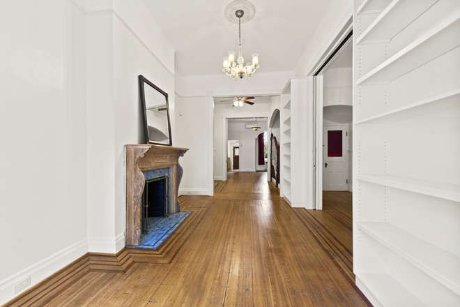 Front room with entrance foyer on right. Featuring pocket doors and book shelves. - Awesome 4-5 BR home close to JHU UB MICA Loyola. Walk 2 coffee, movies, restaurants w/ yard, parking