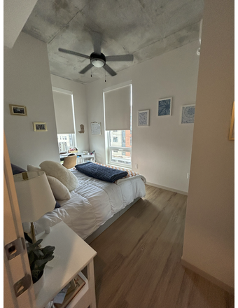 Bedroom: sliding door closet with full length mirror, hardwood floors, desk, chair and nightstand - Hub Knoxville Apartments