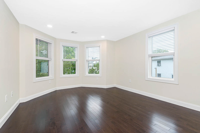 Bedroom - Spacious 7BR/8BA Renovated Home Steps from Tufts & Green Line