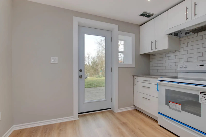 Kitchen looking outside - Newly renovated Studio/Bachelor Unit with backyard walkout in West Rouge Area Apartments