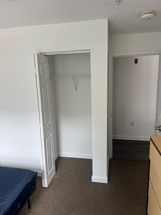 Closet in bedroom - South Campus Commons 4 Apartments