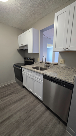 Kitchen with window to the dining area - ****Updated 2 Bedroom 1 Bathroom Apartment with Balcony Next to Campus****New on Market