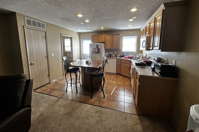 Kitchen with 1/2 bath in the back left - Two BR, 2.5 bath Townhouse 6 blocks from UARK - Looking for 1 mature & clean roommate