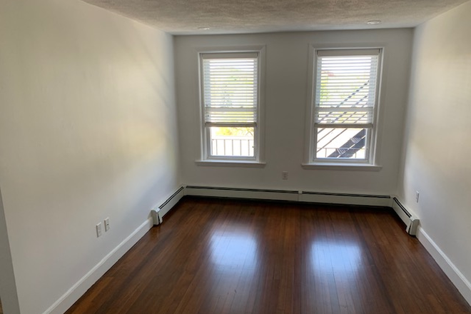 Visit hubrealtyproperties.com - On the Green line T, gorgeous 2 bedroom with dining room, on a tree lined street