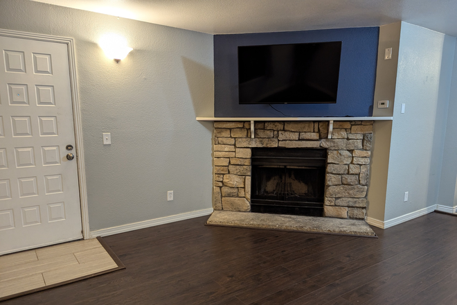 Entry and fireplace - Updated Condo with In-Unit Washer and Dryer, Modern Appliances, and Wood Burning Fireplace