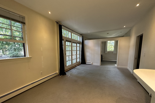 living/dining area, bedroom (with pocket doors) in rear - Beautiful Studio apartment at Brookline Hills T Stop - Separate Bedroom - No fee