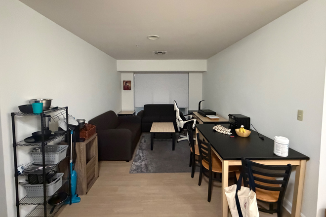 Living space with new flooring - South Campus Commons Building 7 Apartments