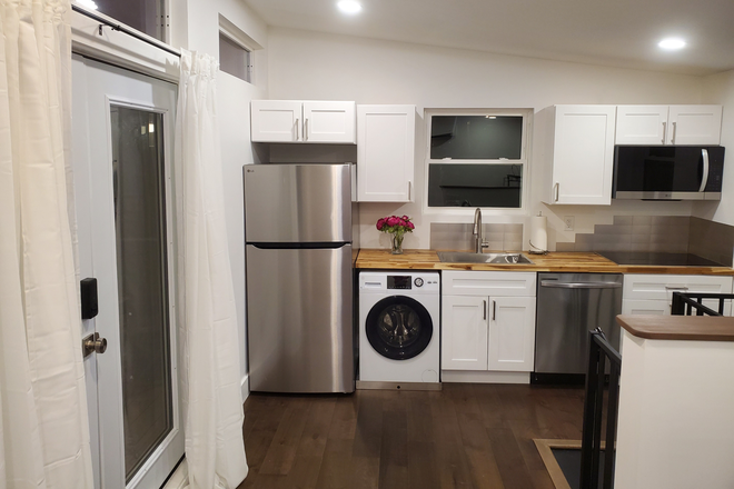 Kitchen with washer/dryer combo in unit, dishwasher, stovetop and full size refrigerator. - 2 Level 2 bedroom Detached Apartment, Pets welcome
