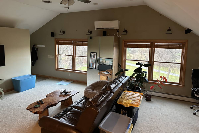 Living room, windows to north and east - Lots of light, open floor plan, gardens, mountain view (Shelburne VT) Apartments