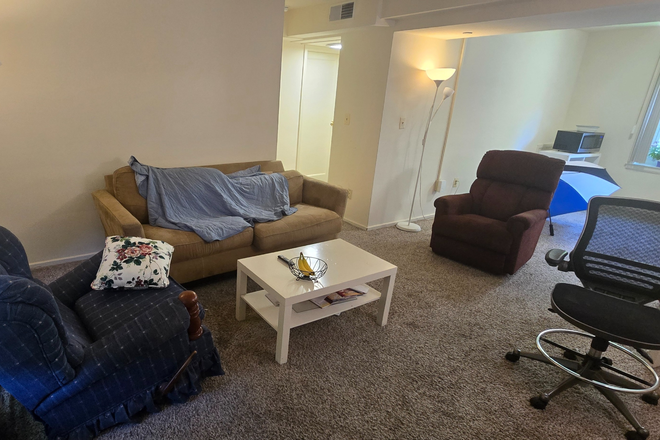 Living Room - A room for a full year lease at Graduate Gardens Apartments
