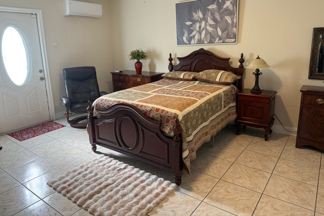Furnished studio with bed, wood furniture, recliner, tile flooring, private entrance and mini-split A/C. - Furnished Private Studio Near FIU – Private Entrance, Bathroom and Parking