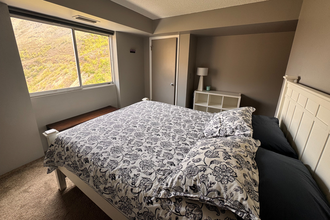 Bedroom - Furnished 1BR Condo with Mountain Views on 7th Floor | Covered Parking | Pool & Gym