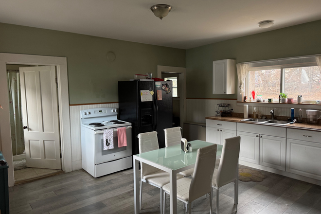 Kitchen and doorways lead to bathroom and in-unit laundry room - One bedroom, one bathroom apartment with in-unit laundry close to campus