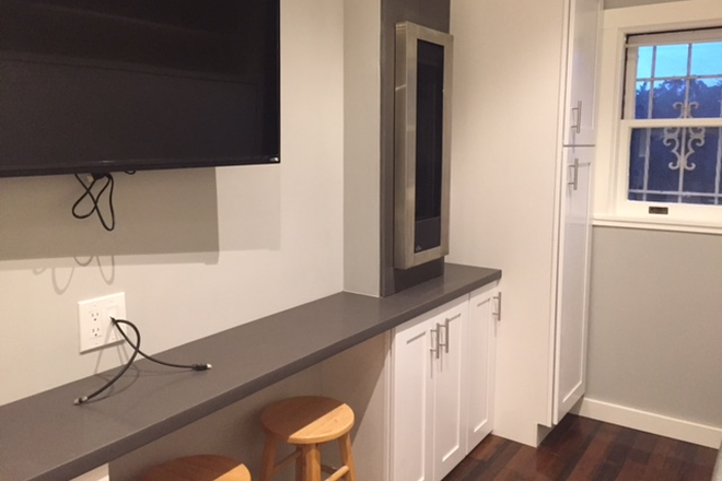 TV, wall heater,  study area, closet. T.V - Studio on the wall House