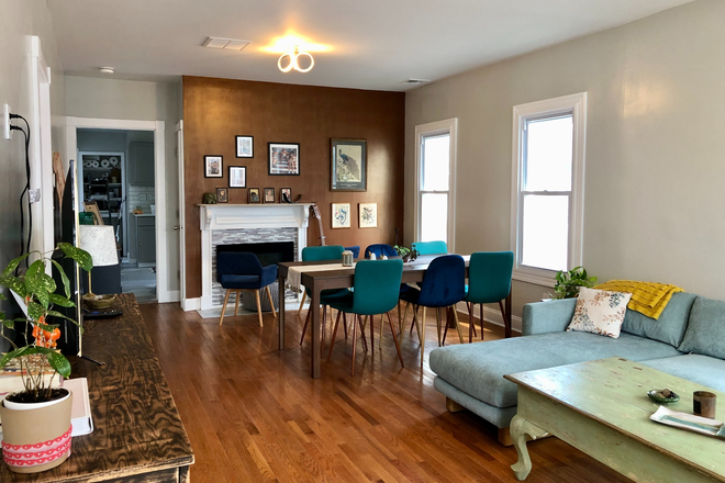 Living room and dining area - Bright bedroom in New Bedford Townhome