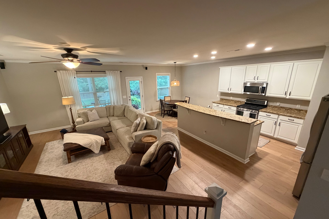Living Room with L-Shaped Couch, Leather Recliner, Large Wooden TV Stand, Smart TV.  Kitchen with Microwave, Fridge, Pantry, and Dishwasher - Fully Furnished 4 Bedroom House in Family Friendly Neighborhood