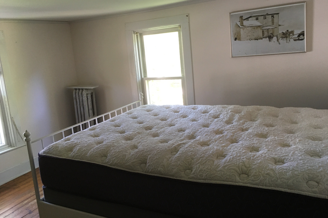The bedroom has windows facing east and north. - Furnished BR, renovated apt, walkable to campus, heat & parking included