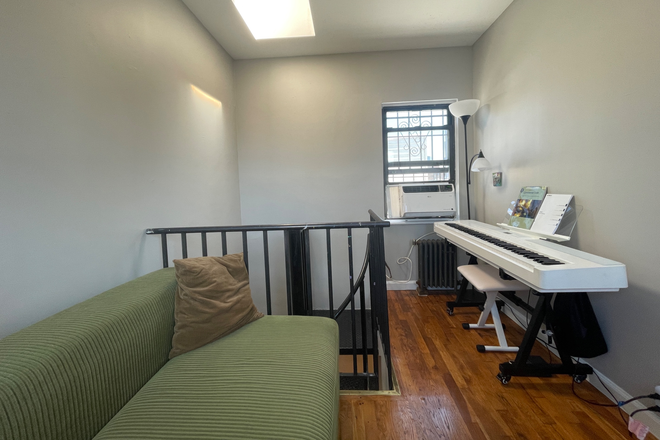 Living room (upstairs) - Bedroom in top-floor duplex with private patio! Apartments