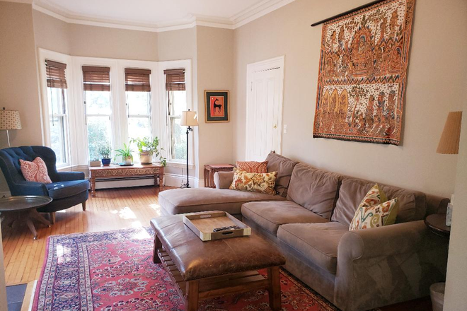 Living Room with Crown Molding and Bay Windows - Grand Victorian 1BR/2BA in the Heart of Union Square. Includes in-unit laundry, parking & patio. House
