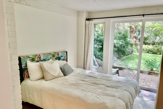 Bedroom looking out onto patio - Sunny Garden Apartment in Palisades Neighborhood