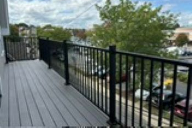 Front balcony overlooking Porter Square shopping center - Heart of Porter Square 4BR, 1.5BA HVAC and W/D Steps to T & Commuter Rail