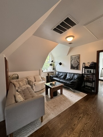 Furnished living room with couches, shelves, smart TV, coffee table - Ditmas Park BK Apartment with back yard.