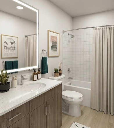 Modern private bathroom featuring a sleek backlit vanity mirror, warm wood cabinetry, and a spa-like design. - Vibe Orlando Apartments